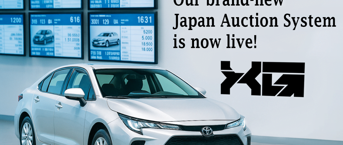 Silver Toyota sedan inside a Japanese car auction hall with live auction monitors in the background